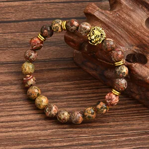 8mm leopard skin jasper stone stretch bracelet with golden lion head charm on wood
