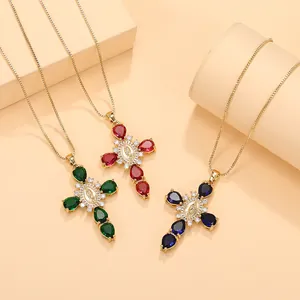 Close-up of religious cross necklaces with colorful pear-shaped gemstones and Mary medals