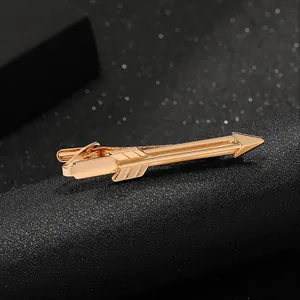Macro shot of gold-plated arrow tie clip for men with a polished metallic finish and details