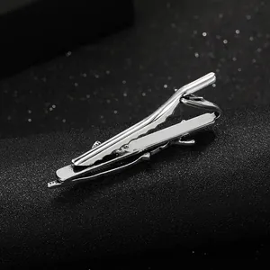 Detailed view of silver men's tie clip with unique tree bark texture on black display
