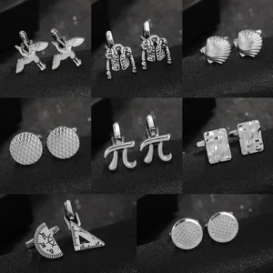 Macro detail of various silver cufflinks featuring crane, pi symbol and geometric tool designs