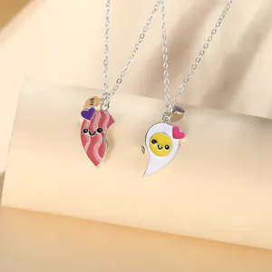 Detail of magnetic hot dog and egg best friends BFF heart pendant necklaces