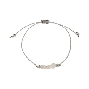 Detailed view of handmade woven rope bracelet with natural irregular crystal stones