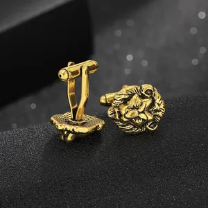 Close-up of vintage lion head cufflinks with detailed engraving and T-back closure