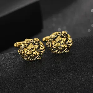 Detailed close-up of golden lion head cufflinks with intricate embossed texture and T-bar