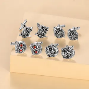 Set of four unique owl-shaped cufflink pairs in antique silver with red rhinestone eyes