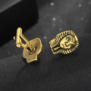 Detailed view of gold Egyptian pharaoh Tutankhamun cufflinks with black enamel accents