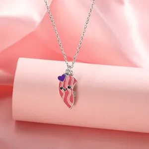 Close-up of cute cartoon bacon BFF pendant with pink enamel and magnetic attraction feature