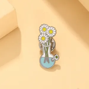 Close-up of enamel daisy pin in blue flask with butterfly clutch back on orange background
