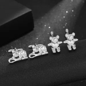 Detailed macro of silver lion and bear animal cufflinks with sparkling stone eyes