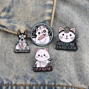 Detail of four creative cartoon medical cat and dog enamel pins on denim fabric backdrop