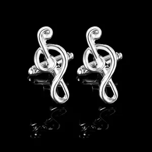 Detailed macro shot of silver polished treble clef cufflinks for business suits