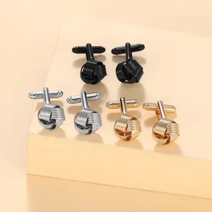 Detailed view of three pairs of twist knot cufflinks in black, silver, and gold finish