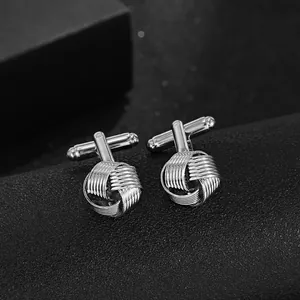 Macro shot of silver twisted knot cufflinks with bullet back closure for men's shirts