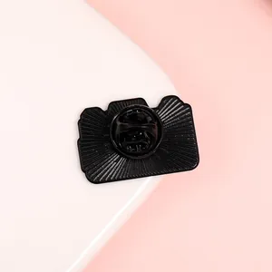 Macro shot of camera enamel pin back with standard butterfly clutch and radial texture