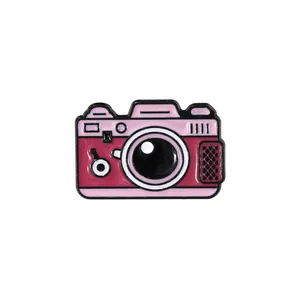 Retro cartoon camera enamel pin in pink and magenta for jackets and backpacks