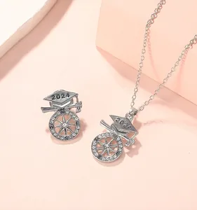 Detailed close-up of 2024 graduation necklace with mortarboard and sparkling crystals