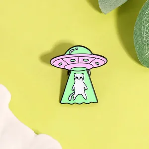 Creative UFO cat enamel pin featuring a cute alien kitten design for jackets and bags