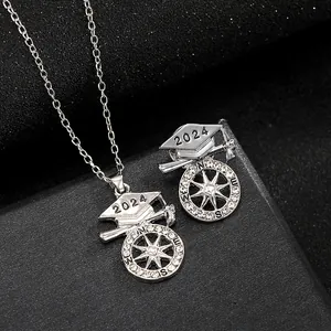 Macro view of 2024 graduation cap jewelry set with compass star design and silver crystals