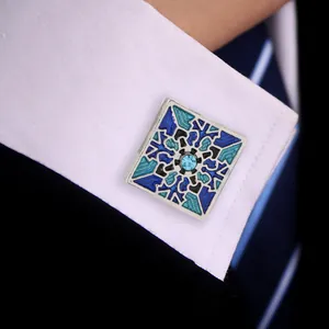 Detail of square cufflinks with blue mosaic enamel and center crystal on French cuff