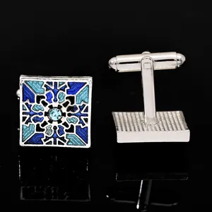 Detail of square vintage cufflinks featuring blue enamel pattern and central crystal inlay