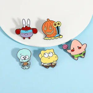 Close-up of five colorful enamel pins featuring cute sea creatures on a blue base