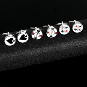 Close-up of silver-tone poker cufflinks featuring spade, chip, and card suit designs