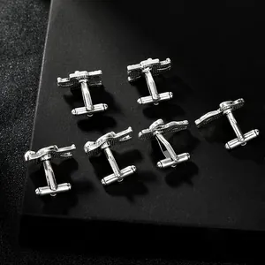Detailed view of silver astronaut style cufflinks with textured metallic finish