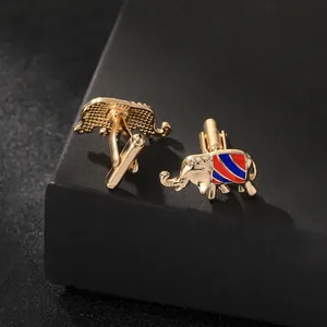 Macro shot of gold elephant cufflinks with red and blue enamel stripes for formal shirts