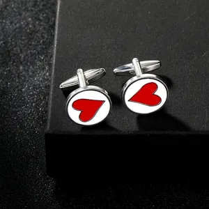 Macro shot of silver poker heart cufflinks on a premium black textured jewelry box