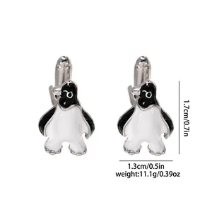 Detailed size view of silver penguin cufflinks with black and white enamel finish