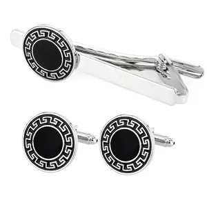Silver-tone round cufflinks and tie clip set with Greek key pattern on black enamel