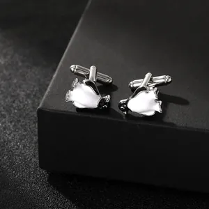 Detail view of penguin-shaped enamel cufflinks with silver metal bullet back closure