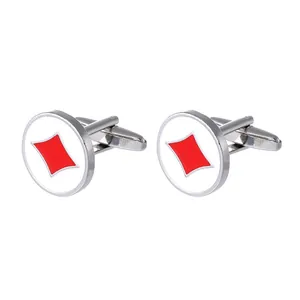 Detail of round silver cufflinks with white enamel and red diamond poker pattern