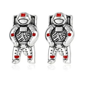 Stylized astronaut cufflinks in vintage silver finish with vibrant red enamel details