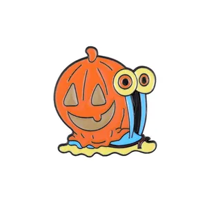Macro detail of cartoon enamel pin with a pumpkin shell snail design for Halloween