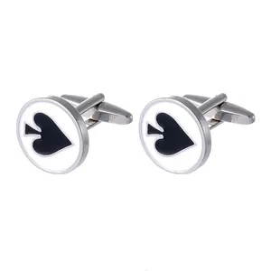 Detailed view of silver poker spade cufflinks with white enamel inlay for dress shirts