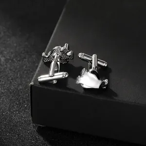 Detailed view of silver penguin cufflinks on a premium black textured gift box