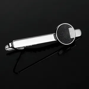 Detailed macro view of silver tie clip with black round starry frosted metal texture