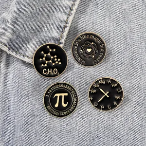 Set of four science and math enamel pins featuring Pi and chemistry icons on denim