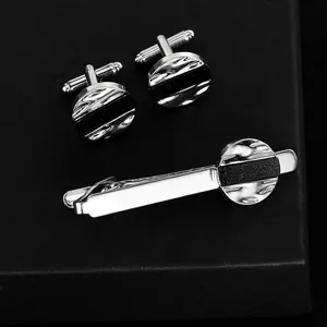 Mens business suit accessory set with silver round cufflinks and matching tie clip
