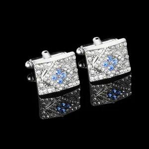 Detailed macro view of square cufflinks with blue and clear zircon crystals