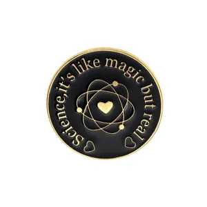 Macro view of Science it's like magic but real enamel pin with atom and heart design