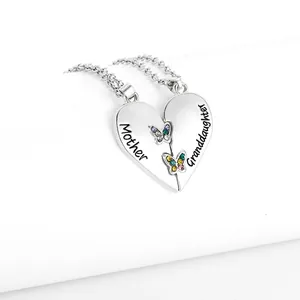 Close-up of silver heart necklace with Mother and Granddaughter text and colorful butterflies