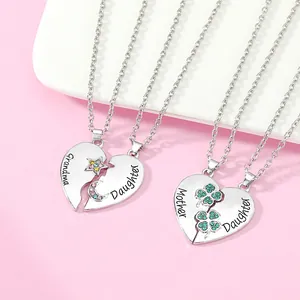 Detail of interlocking heart necklaces with Grandma Mother and Daughter engravings