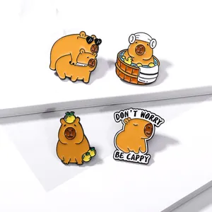 Close-up of four cute capybara enamel pins with creative poses and cartoon character style