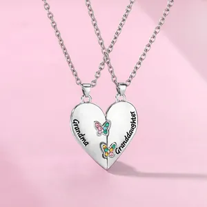 Detail of interlocking heart necklace set with Grandma Granddaughter engraving and butterflies
