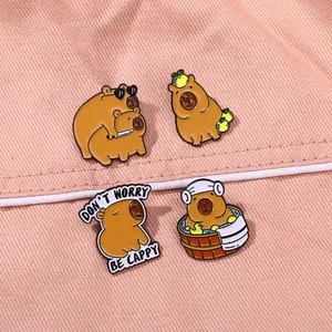 Set of four cute capybara enamel pins including a design with Don't Worry Be Cappy slogan