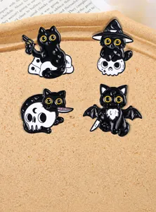 Set of four spooky black cat enamel pins with skulls and bats on a wooden tray