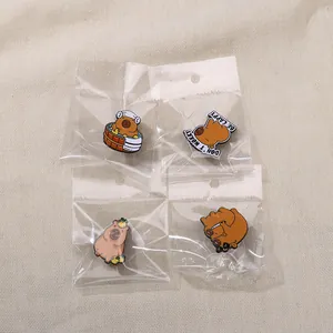 Detailed set of cute capybara enamel pins with Don't Worry Be Cappy text on fabric